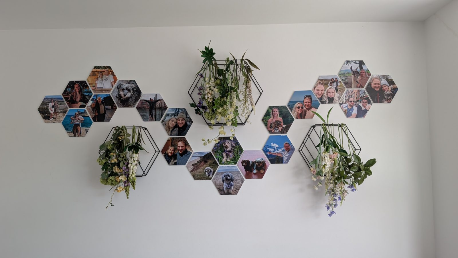Two clusters of hexagon photo tiles spread across a living-room wall