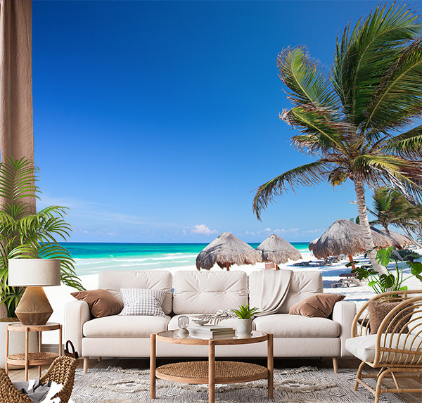 Caribbean beach in Tulum, Mexico with Crystal-clear turquoise waters & pristine white sand, framed by swaying palm trees and thatched umbrellas.